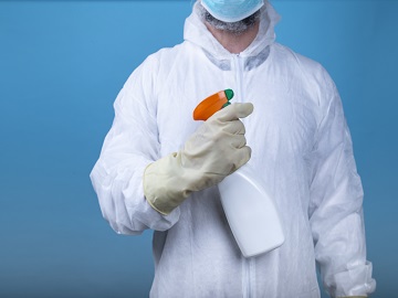 Testing of biopesticide spray used by person in white suit